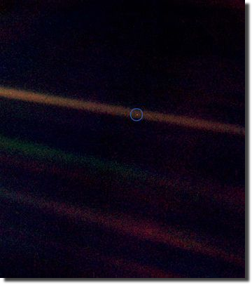 Seen from 6.4 billion kilometres away, Earth is a dot obscured in a beam of scattered sunlight (pinpointed by artificial blue circle).